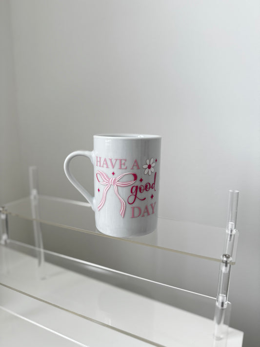 Keramiktasse „Have a Good Day“ mit Schleifen- und Blumenmotiv